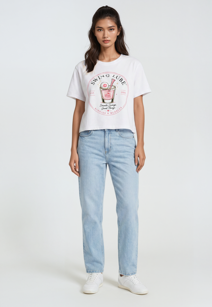 Woman wearing a white t-shirt with a graphic design and light blue jeans on a white background