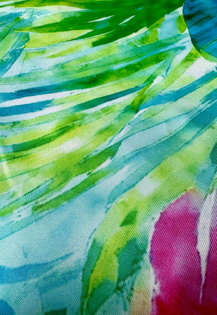 Close-up of a colorful fabric with green, blue, and pink patterns