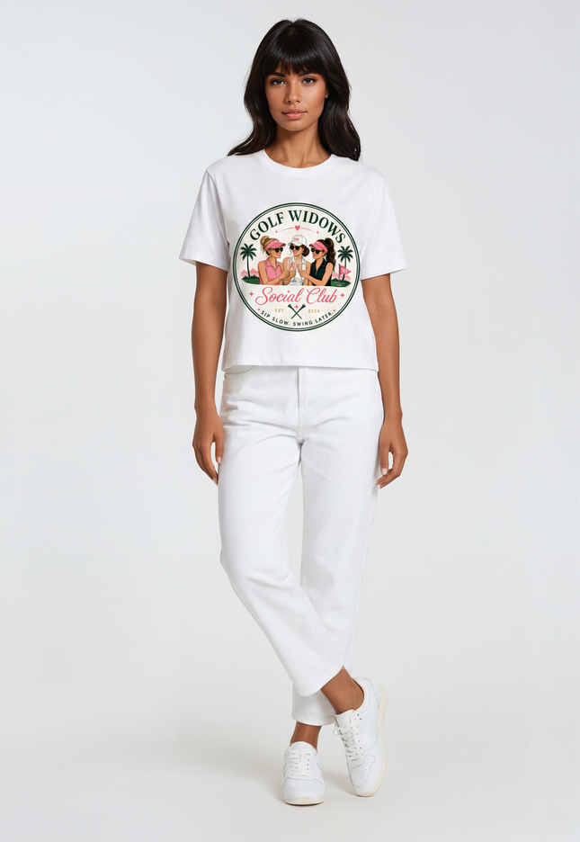 Person wearing a white t-shirt with a graphic design text Golf Widows Social Club on a white background