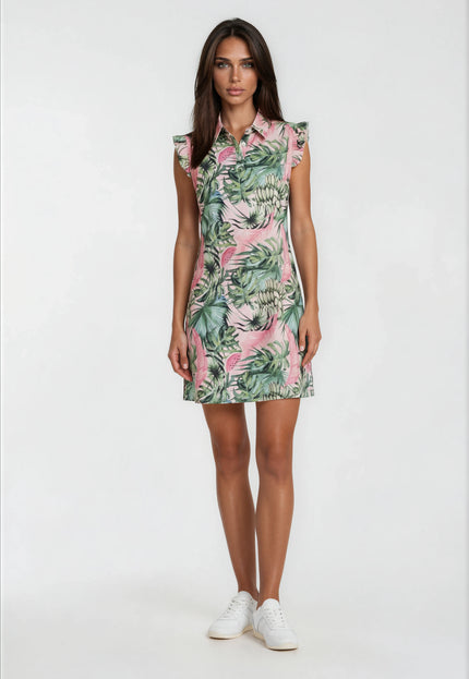 Female model wearing a pink watermelon print golf dress with green tropical leaves and ruffle sleeves