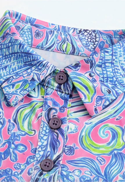 Colorful patterned birdies & bubbles golf dress with buttons on a white background