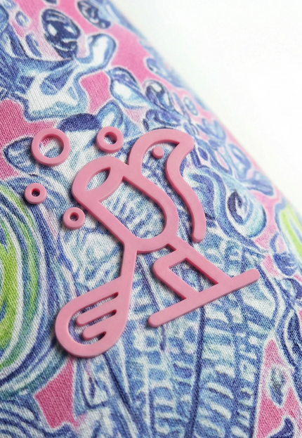 Close-up of a colorful fabric with a pink 'Birdies & Bubbles' logo.
