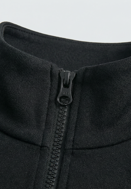 Close-up of a black jacket with a zipper on a light gray background